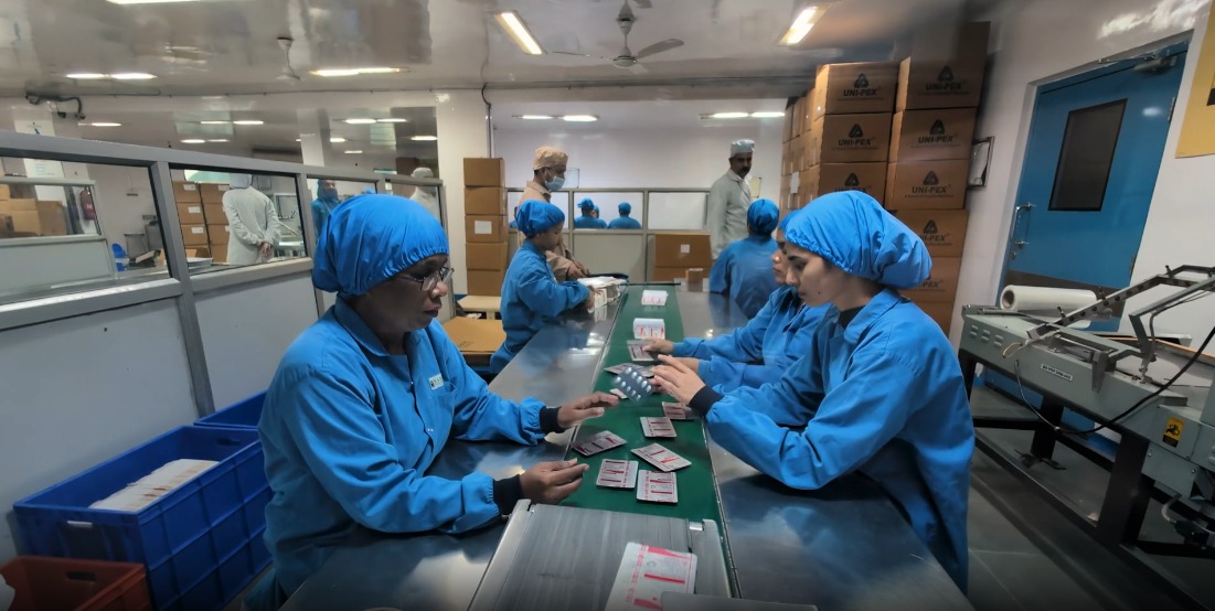 Packaging team inspecting blister strips
